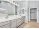Bathroom featuring double sinks, a large mirror, cabinets and easy access to the walk-in closet at 25536 W Primrose Ln, Buckeye, AZ 85326