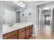 Bathroom featuring a single sink vanity with dark wood cabinets and a large mirror at 25536 W Primrose Ln, Buckeye, AZ 85326