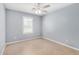 Cozy bedroom with tile flooring, neutral walls, ceiling fan and a window providing natural light at 25536 W Primrose Ln, Buckeye, AZ 85326