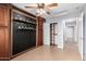 Bedroom with tile floor, ceiling fan, and built-in storage units with shelves at 25536 W Primrose Ln, Buckeye, AZ 85326