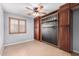 Bedroom with tile floor, ceiling fan, and built-in storage units at 25536 W Primrose Ln, Buckeye, AZ 85326