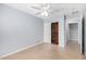 Bright bedroom with tile flooring, ceiling fan, and a closet with sliding doors for storage at 25536 W Primrose Ln, Buckeye, AZ 85326