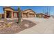 Inviting single-Gathering home with a two-car garage, solar panels, desert landscaping, and a brick-paved walkway at 25536 W Primrose Ln, Buckeye, AZ 85326