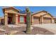 Inviting single-Gathering home with a two-car garage, solar panels, desert landscaping, and a brick-paved walkway at 25536 W Primrose Ln, Buckeye, AZ 85326