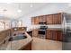 Well-equipped kitchen features stainless steel appliances, granite countertops, and tile flooring at 25536 W Primrose Ln, Buckeye, AZ 85326