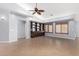 Bright, open living room features built-in cabinets, tile flooring, and a ceiling fan at 25536 W Primrose Ln, Buckeye, AZ 85326