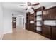 Cozy living area offers built-in shelving, a ceiling fan, and tile flooring, perfect for relaxation at 25536 W Primrose Ln, Buckeye, AZ 85326