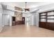 Bright, open living room features stone accent wall, built-in cabinets and tile flooring at 25536 W Primrose Ln, Buckeye, AZ 85326
