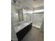 Modern bathroom featuring double sinks, granite countertops, and a glass-enclosed shower at 2672 E Bluff Spring Ave, Apache Junction, AZ 85119