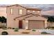 Inviting two-story home with a neutral color palette, tile roof, and low-maintenance desert landscaping at 2672 E Bluff Spring Ave, Apache Junction, AZ 85119