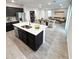 Modern kitchen showcases a spacious island with granite countertops and dark cabinetry, with an open-concept layout at 2672 E Bluff Spring Ave, Apache Junction, AZ 85119