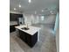 Open-concept kitchen with stainless steel appliances, granite countertops, and seamless transition to the living area at 2672 E Bluff Spring Ave, Apache Junction, AZ 85119
