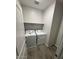 Bright laundry room with wood-look tile, washer, dryer, and upper shelving at 2672 E Bluff Spring Ave, Apache Junction, AZ 85119