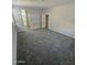 Spacious main bedroom with gray carpet leading to an en-suite bathroom with a large window at 2672 E Bluff Spring Ave, Apache Junction, AZ 85119