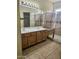 Bathroom features a double sink vanity, tiled shower with bench, and neutral tiling at 28202 N Willemite Dr, San Tan Valley, AZ 85143