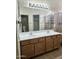 Bathroom featuring a double sink vanity, large mirror and tiled shower at 28202 N Willemite Dr, San Tan Valley, AZ 85143