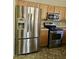 The kitchen features honey oak cabinets and updated stainless steel appliances at 28202 N Willemite Dr, San Tan Valley, AZ 85143