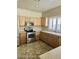 Cozy kitchen showcasing stainless steel appliances, honey oak cabinets, and natural light at 28202 N Willemite Dr, San Tan Valley, AZ 85143