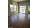 Bright living room features gleaming hardwood floors and sliding glass doors to the backyard at 28202 N Willemite Dr, San Tan Valley, AZ 85143