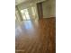 Bright living room featuring hardwood floors, a sliding glass door, and neutral walls at 28202 N Willemite Dr, San Tan Valley, AZ 85143