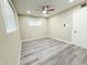 This bedroom boasts light-colored walls, gray toned wood flooring, and ceiling fan at 3338 W Palmaire Ave, Phoenix, AZ 85051