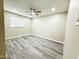 This bedroom boasts light-colored walls, gray toned wood flooring, and natural light at 3338 W Palmaire Ave, Phoenix, AZ 85051