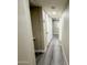 Hallway boasts light-colored walls and gray toned wood flooring at 3338 W Palmaire Ave, Phoenix, AZ 85051