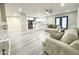 Comfortable living room features gray toned wood floors and easy access to kitchen at 3338 W Palmaire Ave, Phoenix, AZ 85051