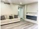 Stylish living room with a modern fireplace and gray toned wood flooring at 3338 W Palmaire Ave, Phoenix, AZ 85051