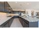 Modern kitchen with granite countertops, backsplash, and gray cabinets at 3483 W Sunstone Dr, San Tan Valley, AZ 85144
