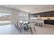 Open kitchen and dining area with a large island, modern lighting, and access to the patio at 3483 W Sunstone Dr, San Tan Valley, AZ 85144