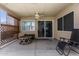 Relaxing covered patio with ceiling fan, outdoor furniture, and view into home's interior at 3514 W Sands Dr, Glendale, AZ 85310