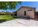 View of a cozy backyard with a covered patio, green lawn, and a small garden, perfect for relaxing and outdoor entertainment at 3514 W Sands Dr, Glendale, AZ 85310