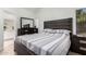 Well-lit bedroom with a striped bedspread and neutral walls at 3514 W Sands Dr, Glendale, AZ 85310