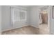 Bedroom with hardwood floors, light, and access to the bathroom at 3514 W Sands Dr, Glendale, AZ 85310
