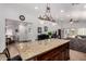 Open floor plan with kitchen island connected to a living room and dining room at 3514 W Sands Dr, Glendale, AZ 85310