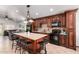 Modern kitchen with stone counters, wooden cabinets, backsplash, and black appliances at 3514 W Sands Dr, Glendale, AZ 85310
