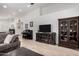 Bright living room featuring light floors, entertainment center, a cabinet and a piano at 3514 W Sands Dr, Glendale, AZ 85310