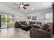 Spacious living room with a vaulted ceiling, ceiling fan, and sliding door access to the backyard at 3514 W Sands Dr, Glendale, AZ 85310