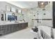 Modern bathroom with double vanity, soaking tub, glass shower and contemporary lighting fixtures at 36004 N Prickley Pear Rd, Cave Creek, AZ 85331
