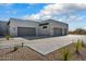 Modern home with a spacious driveway leading to multiple garage doors and desert landscaping at 36004 N Prickley Pear Rd, Cave Creek, AZ 85331