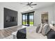 Bright main bedroom featuring hardwood floors, a ceiling fan, and a sliding glass door leading to the backyard at 36004 N Prickley Pear Rd, Cave Creek, AZ 85331