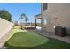 Large backyard featuring a putting green, swimming pool and spa, covered patio and low maintenance landscaping at 44390 W Buckhorn Trl, Maricopa, AZ 85138