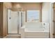 Bathroom featuring a shower and a tub next to a window with blinds at 44390 W Buckhorn Trl, Maricopa, AZ 85138