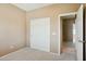 Clean bedroom featuring carpet flooring and a slider door closet at 44390 W Buckhorn Trl, Maricopa, AZ 85138