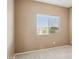 Bedroom featuring neutral walls, carpeted floor, and a window with blinds at 44390 W Buckhorn Trl, Maricopa, AZ 85138