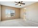Bedroom featuring neutral walls, carpeted floor, and a large window with blinds at 44390 W Buckhorn Trl, Maricopa, AZ 85138