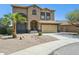 Two story home with desert landscaping and attached two car garage at 44390 W Buckhorn Trl, Maricopa, AZ 85138