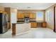 Bright kitchen featuring modern appliances, island, and tile flooring at 44390 W Buckhorn Trl, Maricopa, AZ 85138
