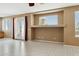 Open-concept living room with French doors and neutral paint tones at 44390 W Buckhorn Trl, Maricopa, AZ 85138
